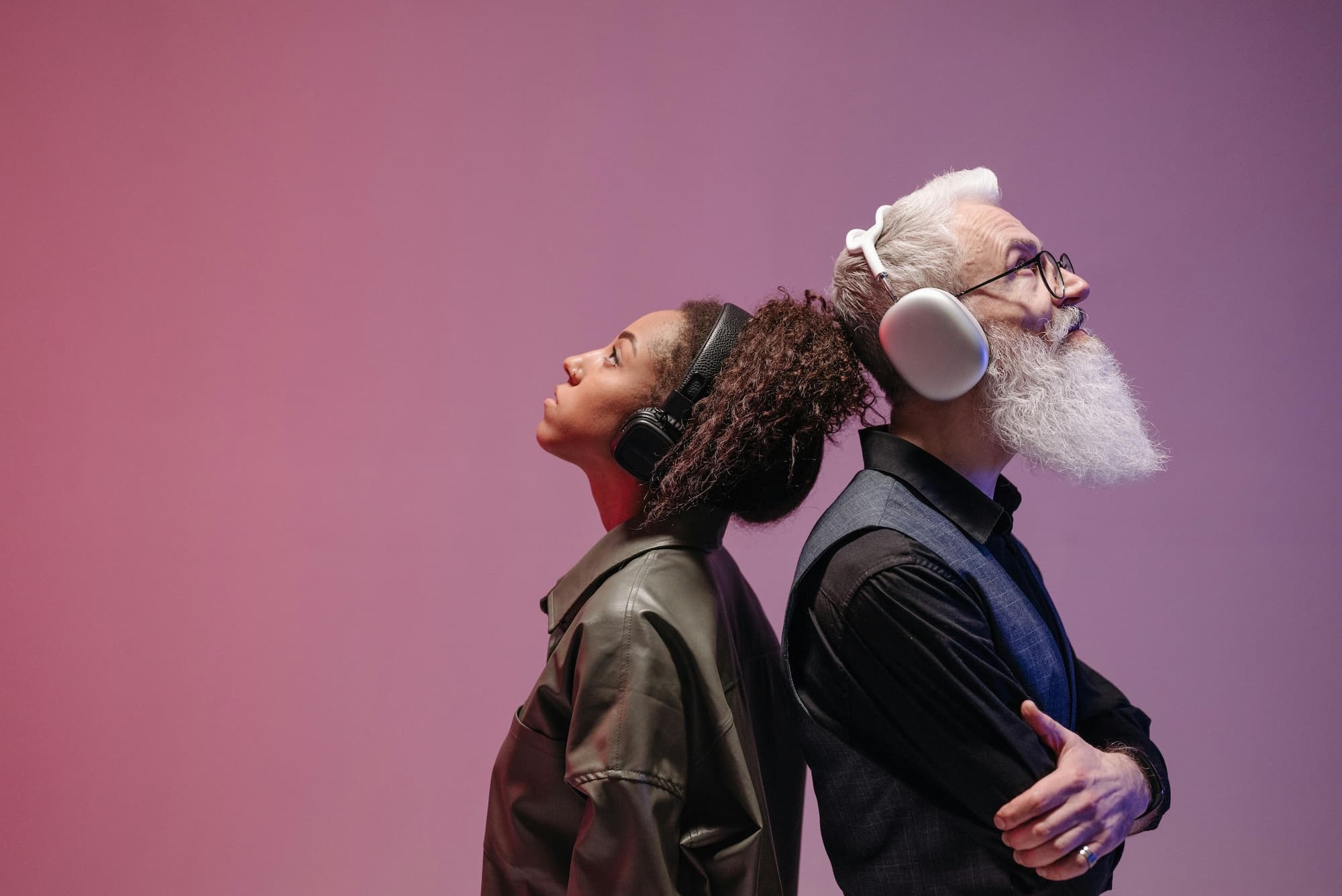 Man and woman listening music through headphones.